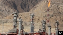 FILE - A gas flare burns in a gas refinery in South Pars gas field, on the northern coast of the Persian Gulf, in Asalouyeh, Iran, Jan. 22, 2014.