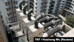 A view of a device created by company Chakr Innovation to remove soot from diesel general exhaust, to clean the air and to allow ink to be created from soot, on a building in Gurgaon, a satellite city of New Delhi, India, March 19, 2018. 