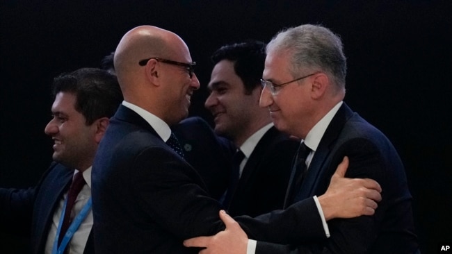 Mukhtar Babayev, COP29 President, right, embraces Simon Stiell, United Nations climate chief, after gaveling a deal for money to curb climate change at the COP29 U.N. Climate Summit in Baku, Azerbaijan, Nov. 24, 2024.