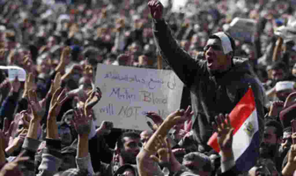 Anti-government protesters react in Tahrir Square, Cairo, Egypt, Friday, Feb. 4, 2011.