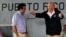 FILE - U.S. President Donald Trump talks with Puerto Rico Governor Ricardo Rossello (L) in a hangar at Muniz Air National Guard Base in Carolina, Puerto Rico, Oct. 3, 2017.