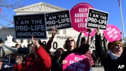 FILE - Protesters on both sides of the abortion issue gather outside the Supreme Court in Washington, Jan. 19, 2018, during the March for Life. The march falls each year around the anniversary of the 1973 Roe v. Wade decision that recognized a legal right to abortion and intends to pressure Congress and the White House to limit legal access to the procedure.