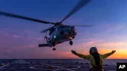 In this undated photo from the Australian Defense Force, a helicopter prepares to take off from the deck of HMAS Hobart off northern Australia. Three new top-secret data centers announced on July 4, 2024, would provide the military with “state-of-the-art collaborative space."