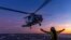 In this undated photo from the Australian Defense Force, a helicopter prepares to take off from the deck of HMAS Hobart off northern Australia. Three new top-secret data centers announced on July 4, 2024, would provide the military with “state-of-the-art collaborative space."