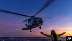 In this undated photo provided by the Australian Defence Force, a Seahawk helicopter prepares to land on the HMAS Hobart. Australia has protested that a Chinese fighter jet endangered a helicopter with flares over international waters, the prime minister said May 7, 2024. 