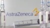 FILE PHOTO: A test tube labelled with the word Vaccine is seen in front of AstraZeneca logo in this illustration taken, September 9, 2020.