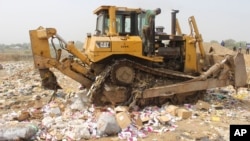 About-to-expire COVID-19 vaccine doses are being destroyed by government workers in Abuja, Nigeria, Dec. 22, 2021. 