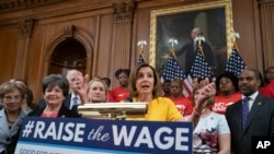 Speaker of the House Nancy Pelosi, D-Calif., joins fellow Democrats and activists seeking better pay as the House approved legislation to raise the federal minimum wage, at the Capitol in Washington, July 18, 2019.
