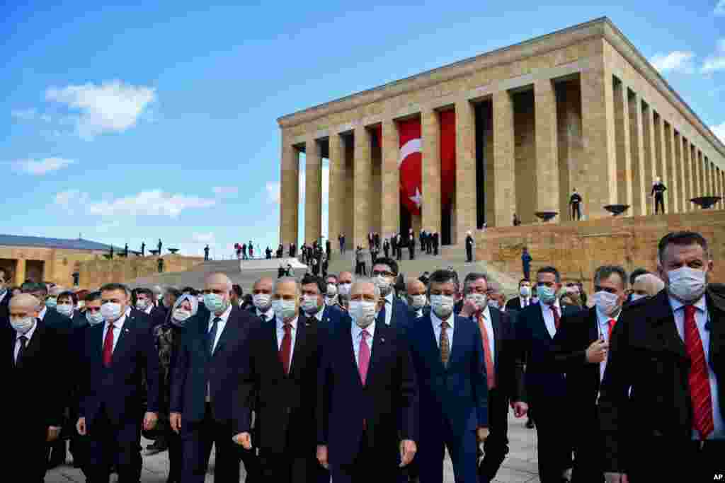 Turkish parliamentarians wearing face masks visit the mausoleum of the country's founder Mustafa Kemal Ataturk during a ceremony marking centennial celebrations for the founding of the Turkish parliament, in Ankara.