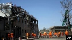 Les lieux de l'explosion nettoyé par des agents municipaux, à Kaboul, le 31 mai 2017.