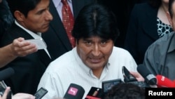 Bolivian President Evo Morales talks to journalists at the Vienna International Airport in Schwechat, July 3, 2013.