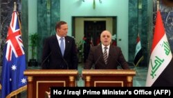 Iraq Prime Minister Haider al-Abadi, right, and his Australian counterpart, Tony Abbott, take part in a press conference in Baghdad, Jan. 4, 2015. 