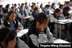 FILE - Students attend a class at the Wenchang Middle School in Yuexi county, during a government-organized media tour in Liangshan Yi Autonomous Prefecture, Sichuan province, China, September 11, 2020. (REUTERS/Tingshu Wang)