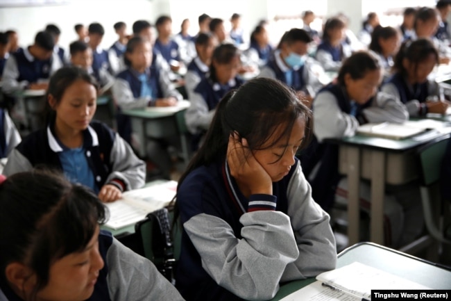 FILE - Students attend a class at the Wenchang Middle School in Yuexi county, during a government-organized media tour in Liangshan Yi Autonomous Prefecture, Sichuan province, China, September 11, 2020. (REUTERS/Tingshu Wang)