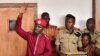 Opposition figurehead Robert Kyagulanyi, aka Bobi Wine, lifts his hand in the dock in the court room in Kampala, April 29, 2019. 