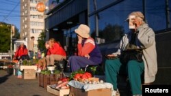 Vendors sell vegetables and other foodstuffs in a street in Izhevsk