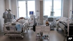 Doctors attend to a patient inside the intensive care unit for people infected with the new coronavirus, at a hospital in Moscow, Russia, May 2, 2020.