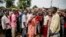Joseph Bendounga (C), a local opposition leader, speaks to a crowd of people angered by an attack on a church in central Bangui, May 29, 2014.