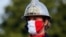 A firefighter wears a face mask with the colors of the French flag, prior to the Bastille Day parade, July 14, 2020 on the Champs Elysees avenue in Paris.