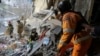 In this photo provided by the Ukrainian Emergency Service, rescuers search for the dead and injured after a Russian drone hit an apartment building in Sumy, Ukraine, Jan. 30, 2025. 