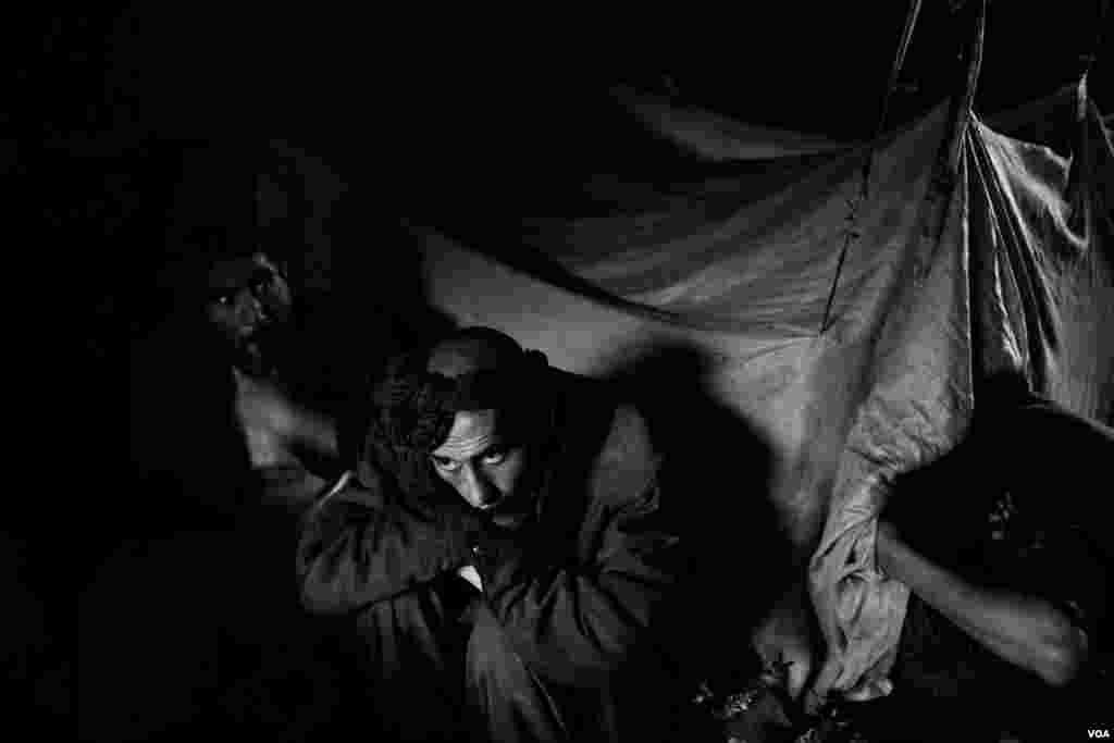 Men smoking drugs under the bridge in Pul e Sukhta. (Maciej Stanik/VOA)