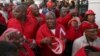 Julius Malema, center, leader of the Economic Freedom Fighters (EFF) party stands outside Parliament after he and party members heckled South African President Jacob Zuma, Cape Town, South Africa, Aug. 21, 2014.