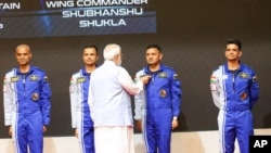 FILE - Indian Prime Minister Narendra Modi presents badges to Indian Air Force pilots who have been shortlisted for India's first space flight during an event at the Vikram Sarabhai Space Center in Thiruvananthapuram, India, Feb. 27, 2024. (Indian Press Information Bureau via AP)