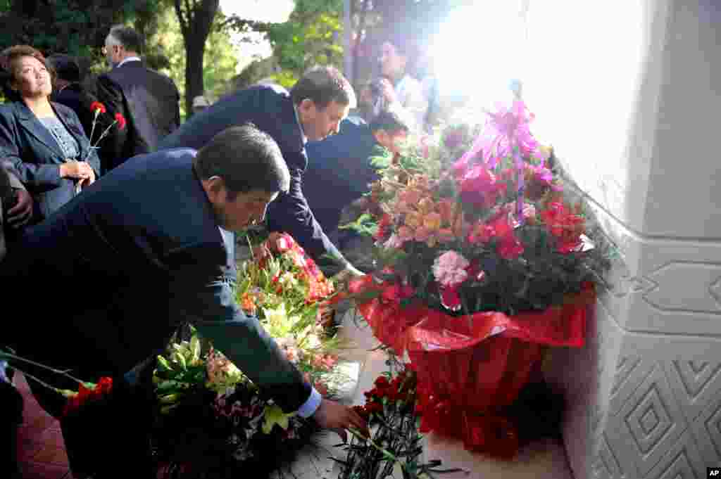 FILE - People lay flower tributes during ceremony marking first anniversary of violence between ethnic Kyrgyz and minority Uzbeks in the southern city of Osh, Kyrgyzstan, June 10, 2011.