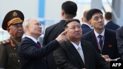 (FILES) In this pool photo distributed by Sputnik agency, Russia's President Vladimir Putin (centre L) and North Korea's leader Kim Jong Un (centre R) visit the Vostochny Cosmodrome in Amur region on September 13, 2023.
