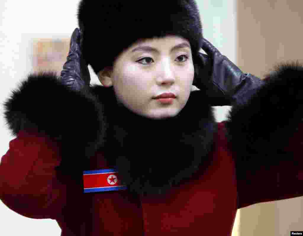 A members of North Korean cheering squad looks at herself in a mirror in a ladies&#39; room in Gapyeong, South Korea.