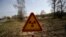 In this photo taken on Monday, April 11, 2016, a radiation warning sign is placed near the check-point 'Maidan' of the state radiation ecology reserve inside the 30 km exclusion zone around the Chernobyl nuclear reactor, some 370 km ( 231 miles) south-ea