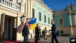 FILE - President Joe Biden, right, meets with Ukrainian President Volodymyr Zelenskyy, center, and Olena Zelenska, left, spouse of President Zelenskyy, at Mariinsky Palace during an unannounced visit in Kyiv, Ukraine, February 20, 2023.