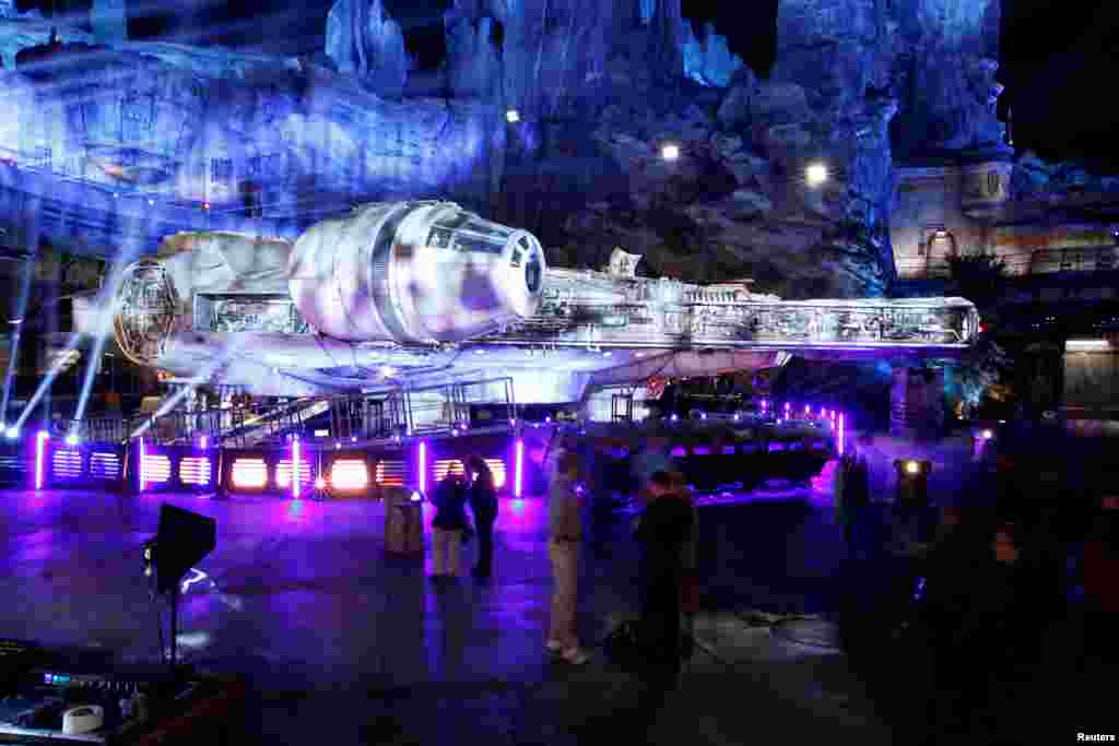 Guests explore &quot;Star Wars: Galaxy&#39;s Edge&quot; near a Millennium Falcon starship at Disneyland Park in Anaheim, California, May 29, 2019.