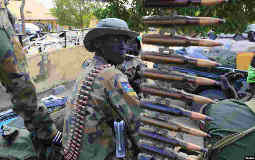 A South Sudan army soldier stands next to a machine gun mounted on a truck in Malakal town, some 500 km (312 miles) northeast of the capital, Juba.