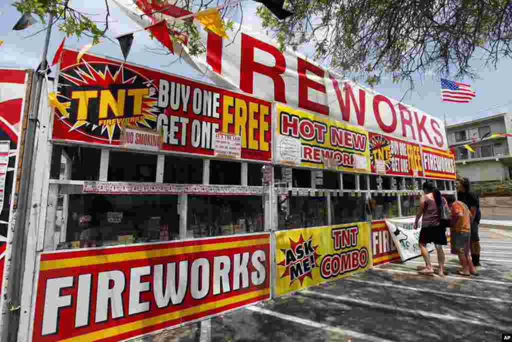 Sebuah keluarga membeli kembang api di kios TNT Fireworks di Taman Monterey, California (2/7),