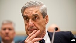 FBI Director Robert Mueller listens as he testifies on Capitol Hill in Washington, June 13, 2013.