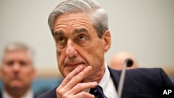 FILE - FBI Director Robert Mueller listens as he testifies on Capitol Hill in Washington, June 13, 2013.