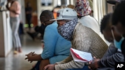 Volunteers wait to be checked at a vaccine trial facility set at Soweto's Chris Sani Baragwanath Hospital outside Johannesburg, South Africa, Nov. 30, 2020. 