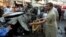 Security officers collect evidence from the site of a suicide bomb attack in Peshawar, November 7, 2012. 