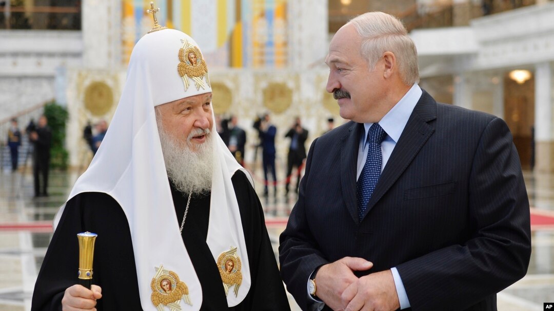 Belarusian President Alexander Lukashenko, right, and Russian Orthodox Church Patriarch Kirill walk during their meeting in Minsk, Belarus, Oct. 15, 2018. 