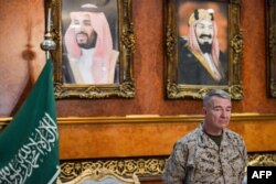 FILE - U.S. Marine Corps General Kenneth F. McKenzie, Commander of the U.S. Central Command, poses for a picture during his visit to a military base in al-Kharj in central Saudi Arabia, July 18, 2019.