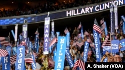 FILE - Supporters and delegates hold up signs before Hillary Clinton's speech on the final night of the Democratic National Convention in Philadelphia, July 28, 2016. (A. Shaker/VOA)