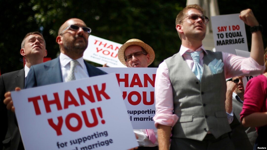 Members of the London Gay Men's Choir perform in front of the Houses of Parliament in central London on July 15, 2013. Their vigil and performances were timed to coincide with the Marriage Bill being read in the House of Lords.