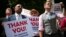 Members of the London Gay Men's Choir perform in front of the Houses of Parliament in central London, July 15, 2013. 