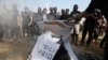 FILE - Anti-LGBTQ+ protesters who managed to break through a police cordon use LGBTQ+ signage to make a bonfire in an area designated for the Tbilisi Pride Fest, in Tbilisi, Georgia, July 8, 2023.