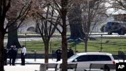 U.S. Secret Service officers stand in the cordoned off area on Pennsylvania Avenue after a security incident near the fence of the White House in Washington, March 18, 2017 