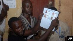 Election workers count legislative ballots after the close of voting, at a polling station in Conakry, Guinea, Sept. 28, 2013. 