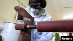 A worker prepares a prosthesis inside the manufacturing workshop of the Physical Rehabilitation Reference Centre in Juba, South Sudan, July 7, 2011. The center, run by the Government of South Sudan in cooperation with the International Committee of the Red Cross (ICRC), started its service provision for physically disabled in January 2009.