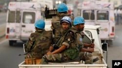 FILE- U.N. soldiers from Niger conduct a patrol through the streets of Abidjan, Ivory Coast, Jan. 10, 2011. The U.N. peacekeeping mission in Ivory Coast ended June 30, 2017, 13 years after forces intervened to implement a peace agreement that left the war-racked economic giant split into two pieces.