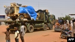 FILE — A military truck belonging to Niger's security forces escorts a French Army military as they crossed the Lazaret district in Niamey, Oct 10, 2023. 